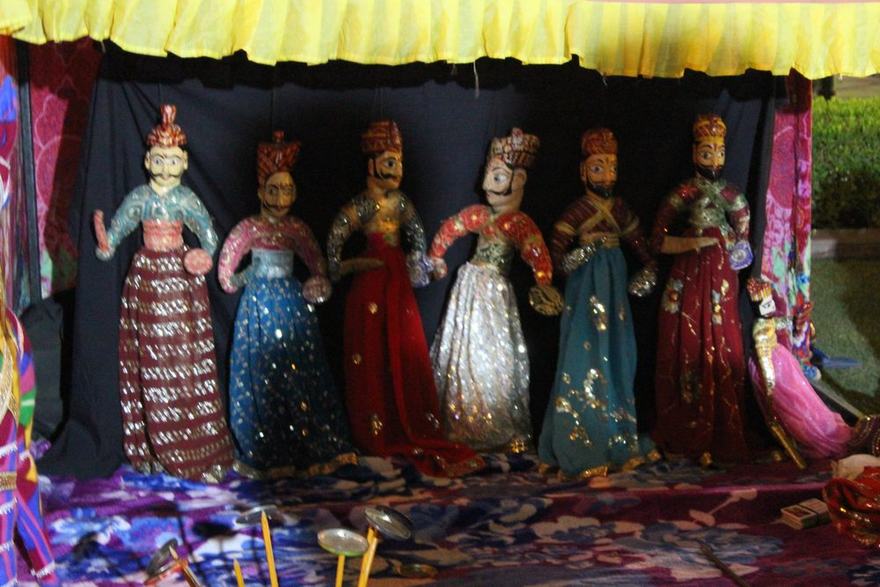 Rajasthani kathputli string puppets in turbans and mirror-work skirts on their stage